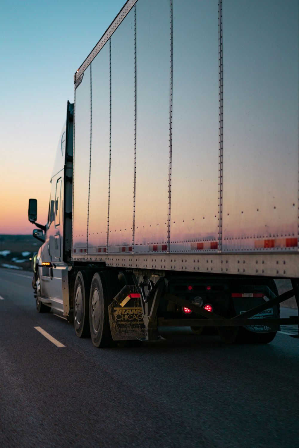Semi trailer on a highway at dusk