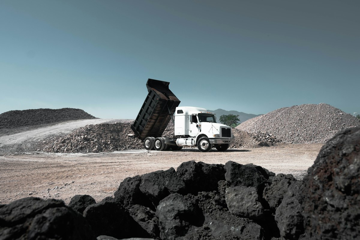 Dump truck unloading crushed stone at a quarry