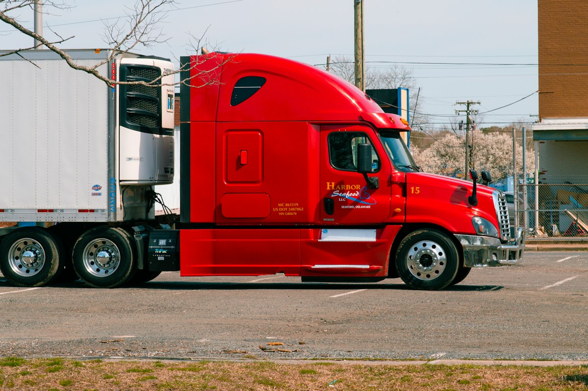 Semi truck with a refrigerated reefer trailer parked at a loading area
