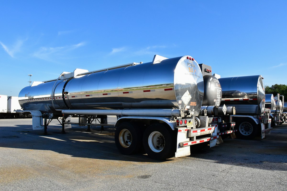 Stainless steel liquid tanker trailers parked side by side